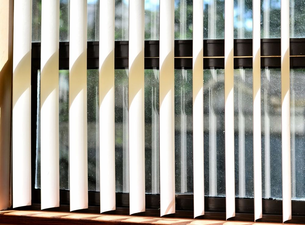 A row of vertical blinds on a wall in a hallway — Dryology Carpet Cleaning in Sydney, NSW
