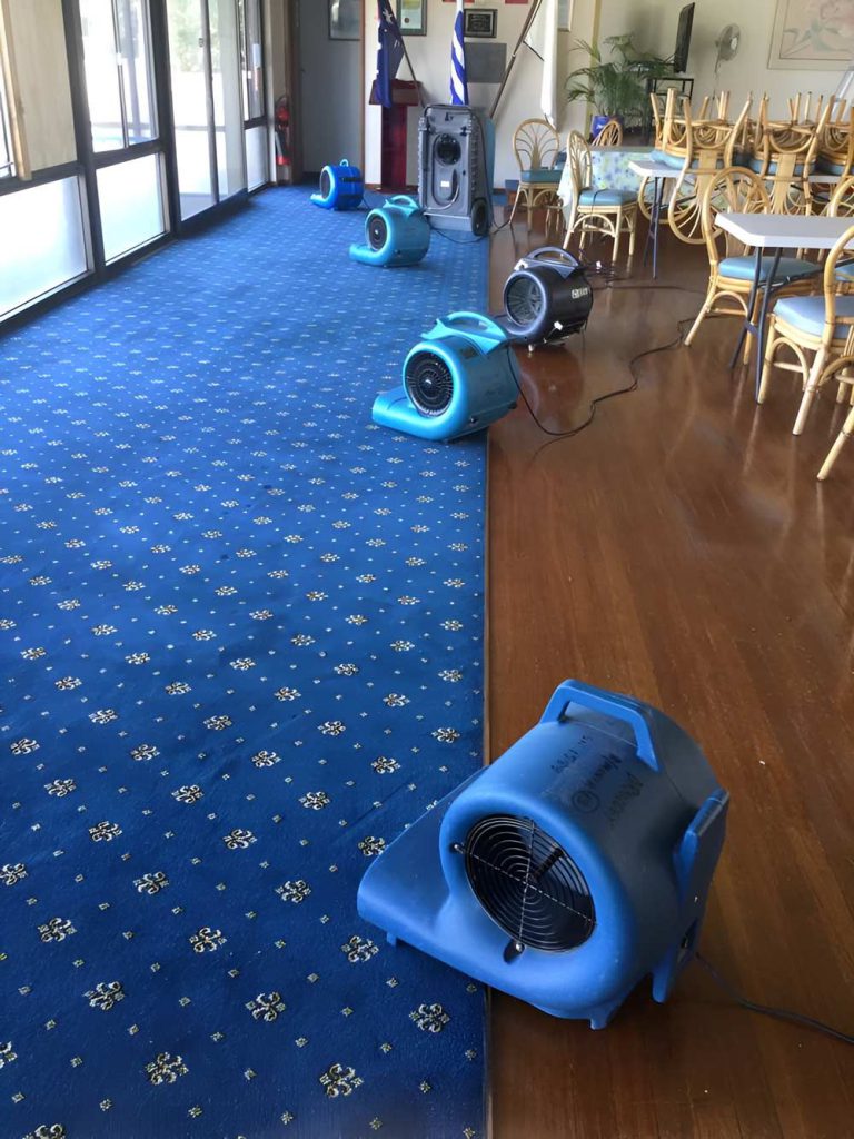 Four Dehumidifier's Drying Out A Classroom With Blue Carpet — Dryology Carpet Cleaning in Salamander Bay, NSW