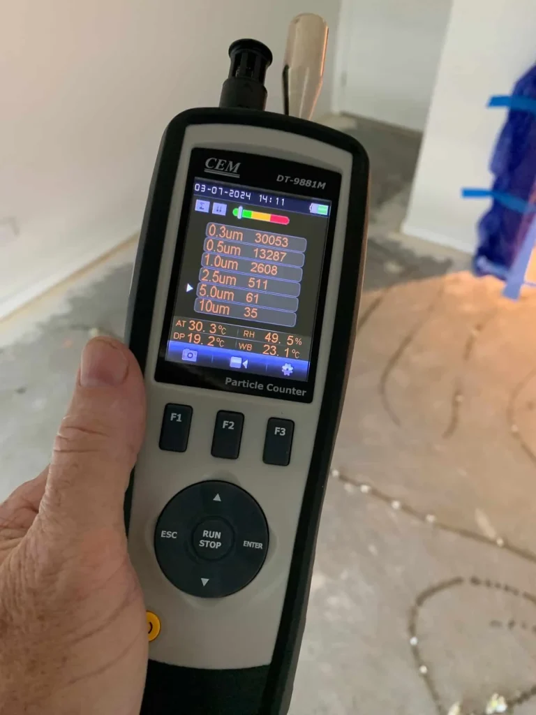 A person is holding a handheld device in their hand — Dryology Carpet Cleaning in Sydney, NSW